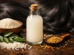 Rice Water for Hair: Benefits, DIY Recipes & How to Use It Glass bottle of homemade rice water for hair surrounded by rice grains and natural Indian hair care ingredients